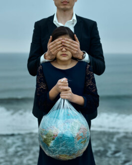Plastic4Future Man hides eyes of child holding a globe wrapped in plastic foil